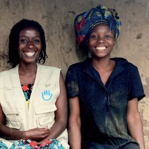 Eine HI-Mitarbeiterin und Rose vor ihrer Hütte im Geflüchtetenlager in Uganda